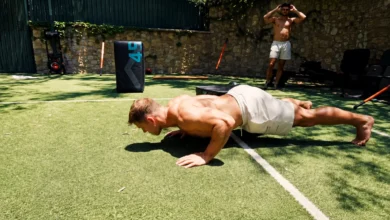 Christian McCaffrey performing advanced pushup variations on an outdoor court during his 2026 offseason workout