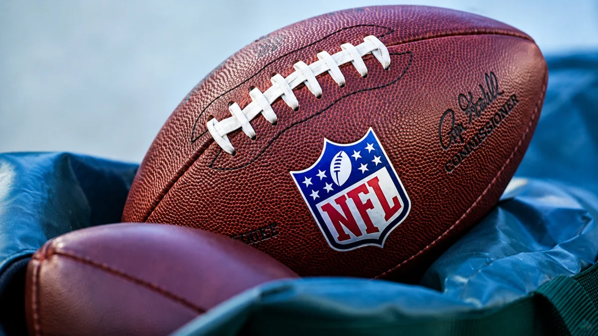 Arizona Cardinals helmet and football on the field during practice