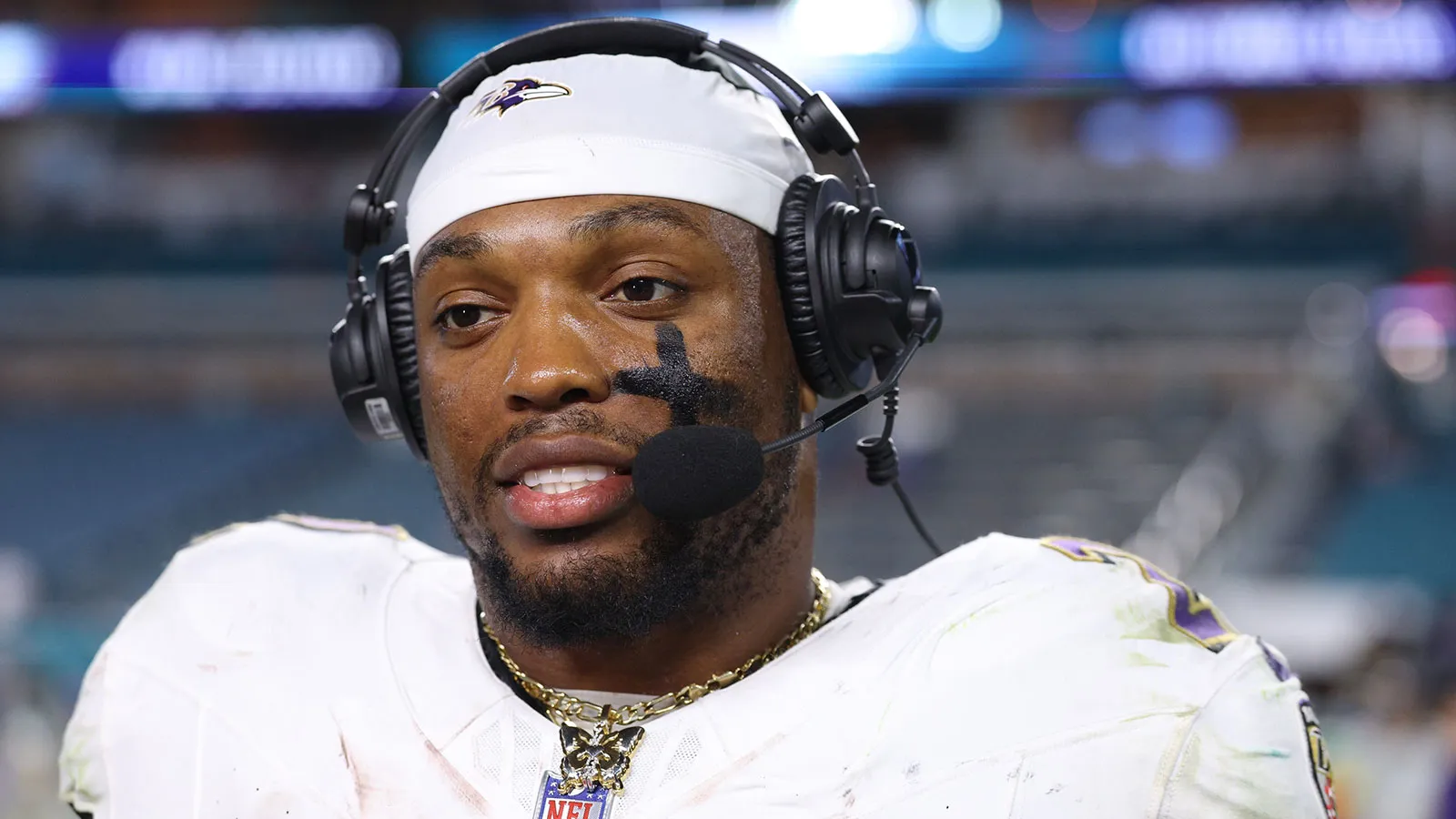 Oct 30, 2025; Miami Gardens, Florida, USA; Baltimore Ravens running back Derrick Henry (22) wears a butterfly necklace during a postgame interview following a w…