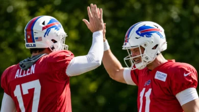 Josh Allen sprays water on a teammate during Buffalo Bills training camp