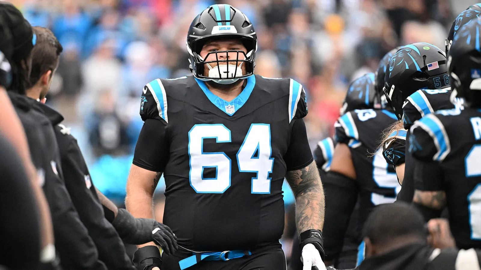 Dec 21, 2025; Charlotte, North Carolina, USA; Carolina Panthers center Cade Mays (64) runs on to the field before the game at Bank of America Stadium. Mandatory…