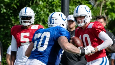 Colts offensive lineman blocks for quarterback Daniel Jones during 2026 training camp drill
