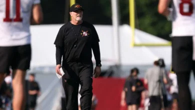 Jul 29, 2026; Ashburn, VA, USA; Washington Commanders head coach Dan Quinn walks on the field on day one of training camp at BigBear.ai Performance Center at Co…