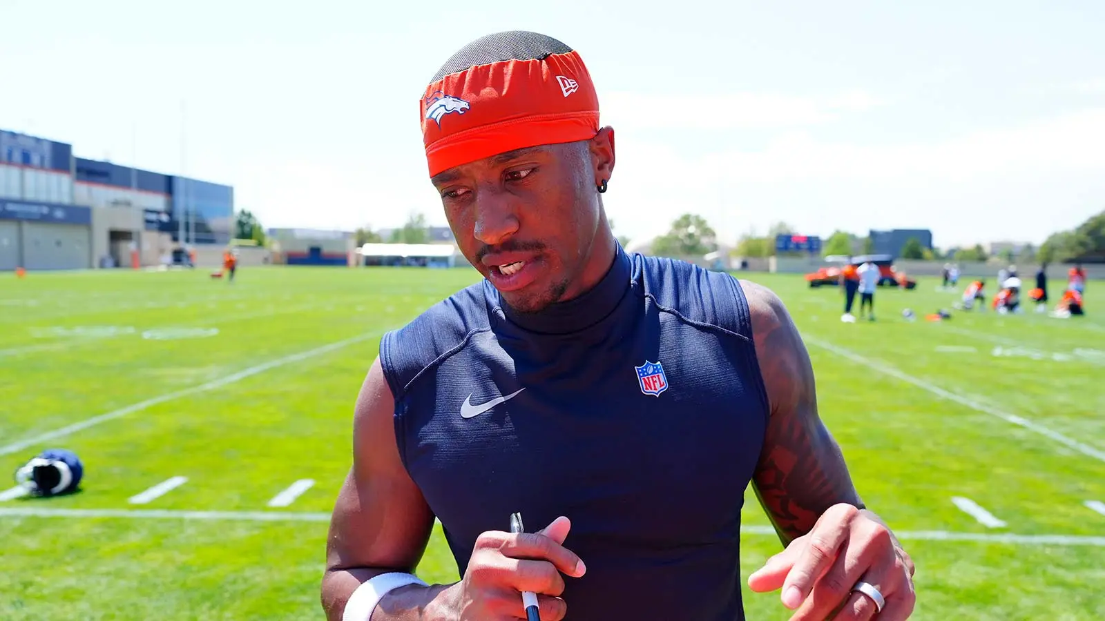 Jul 31, 2026; Englewood, CO, USA; Denver Broncos wide receiver Courtland Sutton (14) signs autographs following training camp at Broncos Park. Mandatory Credit:…