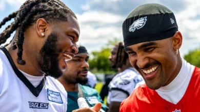 Jalen Carter and Jalen Hurts share a handshake and laugh at Eagles training camp