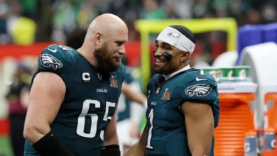 Feb 9, 2025; New Orleans, LA, USA; Philadelphia Eagles offensive tackle Lane Johnson (65) shakes hands with quarterback Jalen Hurts (1) during the second half o…