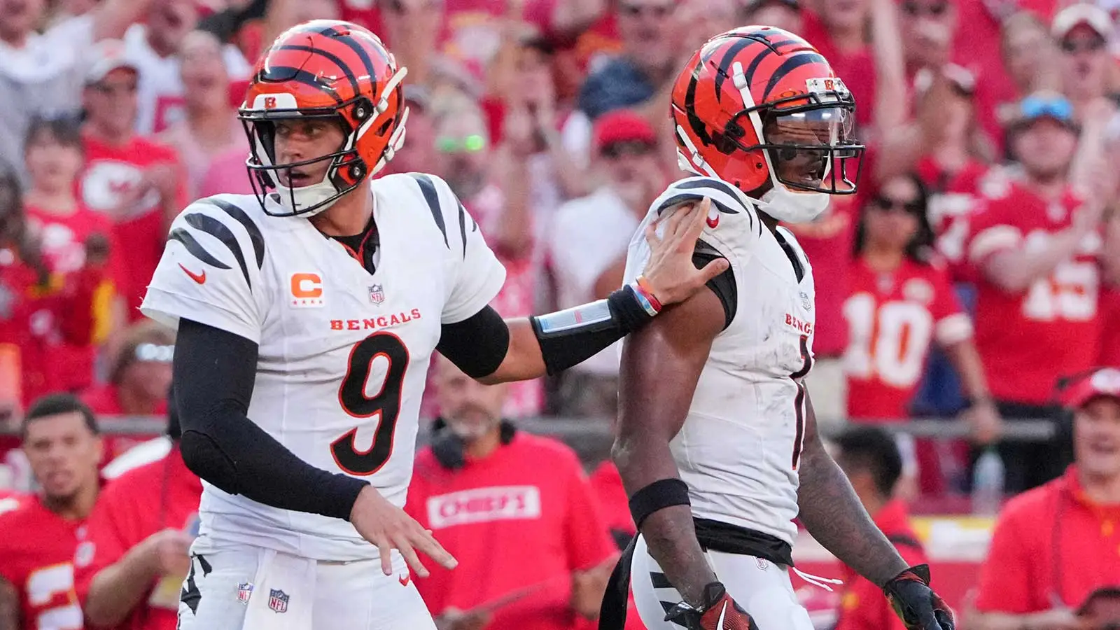 Sep 15, 2024; Kansas City, Missouri, USA; Cincinnati Bengals quarterback Joe Burrow (9) restrains wide receiver Ja'Marr Chase (1) after an altercation with offi…