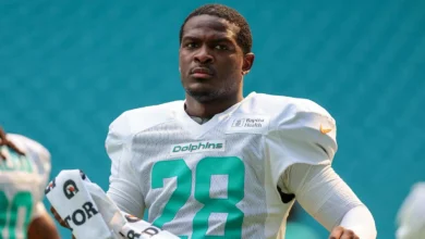 Aug 8, 2026; Miami Gardens, FL, USA; Miami Dolphins running back De'von Achane (28) looks on from the field during practice at Hard Rock Stadium. Mandatory Cred…