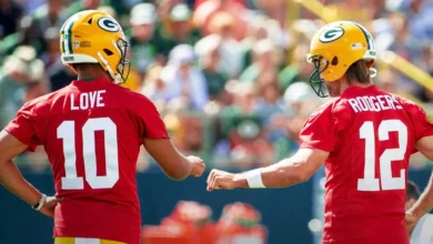 Green Bay Packers quarterback Jordan Love (10) and quarterback Aaron Rodgers (12) fist bump during the third day of training camp Friday, July 30, 2021 in Green…