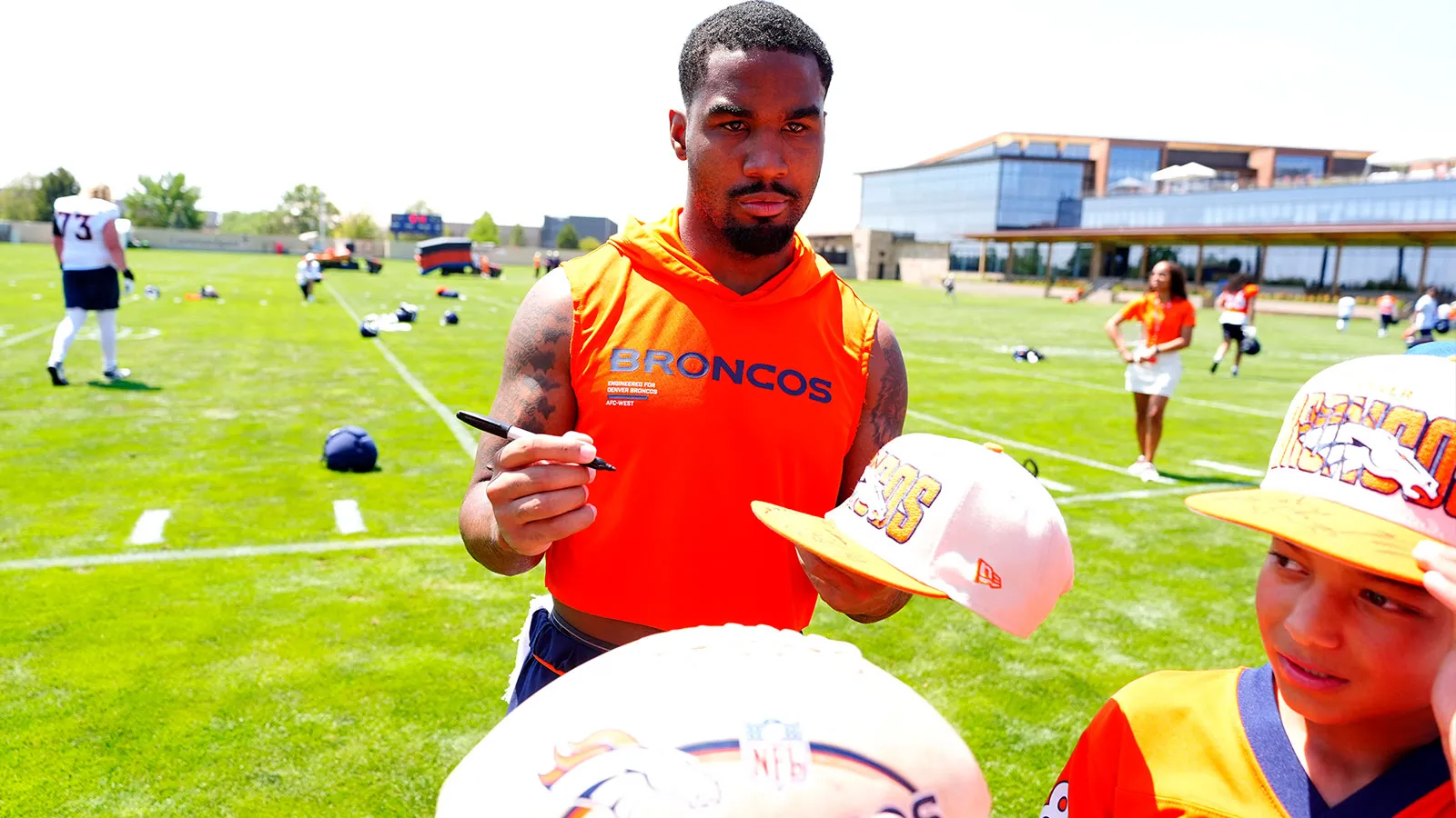 Jul 31, 2026; Englewood, CO, USA; Denver Broncos wide receiver Jaylen Waddle (17) signs autographs following training camp at Broncos Park. Mandatory Credit: Ro…
