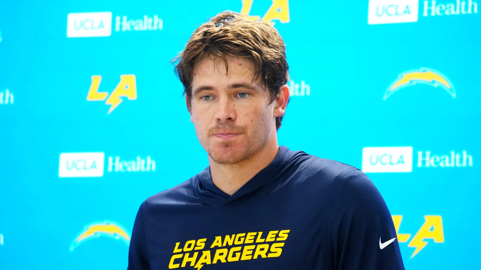 Los Angeles Chargers quarterback Justin Herbert (10) looks on before the game against the New England Patriots in an AFC Wild Card Round game at Gillette Stadiu…