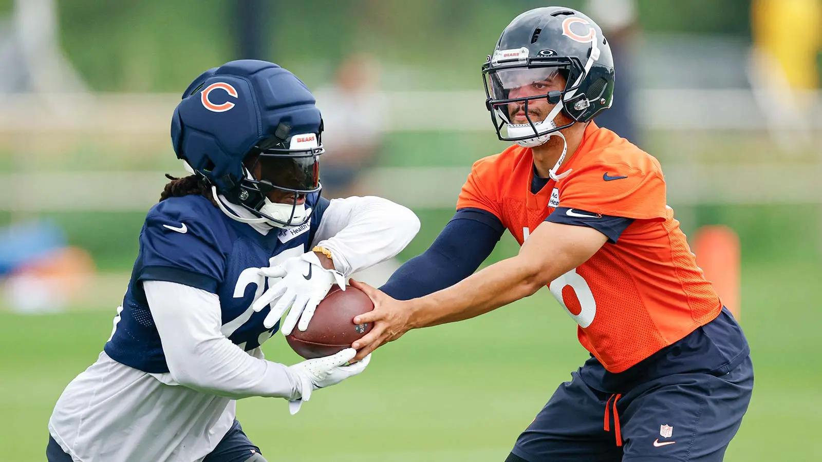 Aug 5, 2026; Lake Forest, IL, USA; Chicago Bears quarterback Caleb Williams (18) passes the ball to running back Kyle Monangai (25) during training camp at Hala…