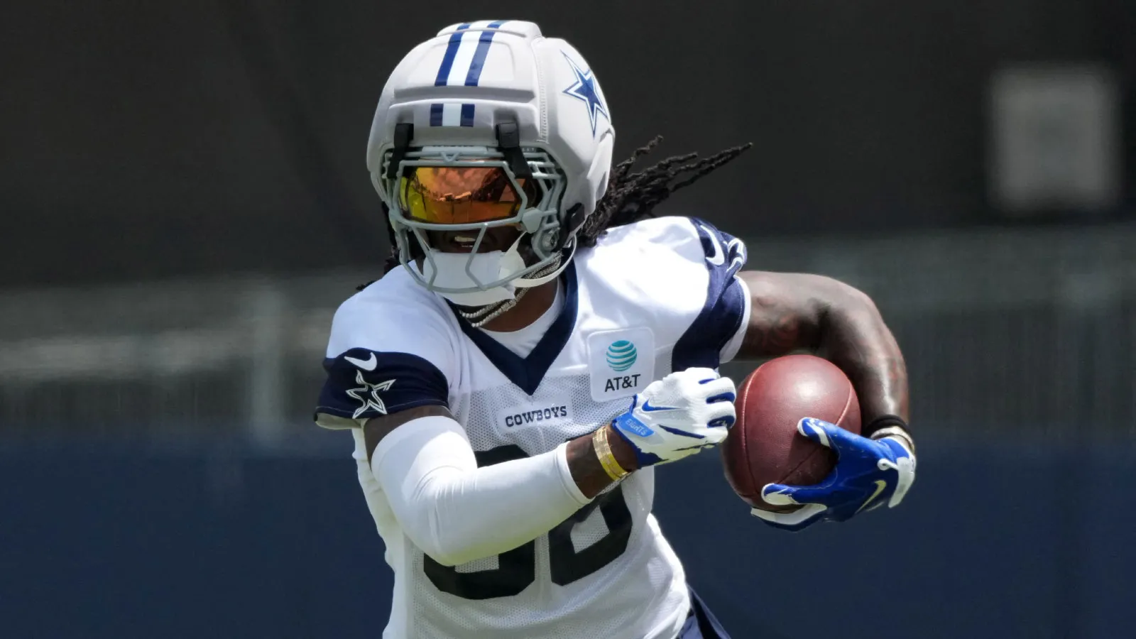 Jul 29, 2026; Oxnard, CA, USA; Dallas Cowboys receiver CeeDee Lamb (88) carries the ball wearing a Guardian helmet cap at training camp at River Ridge Playing F…