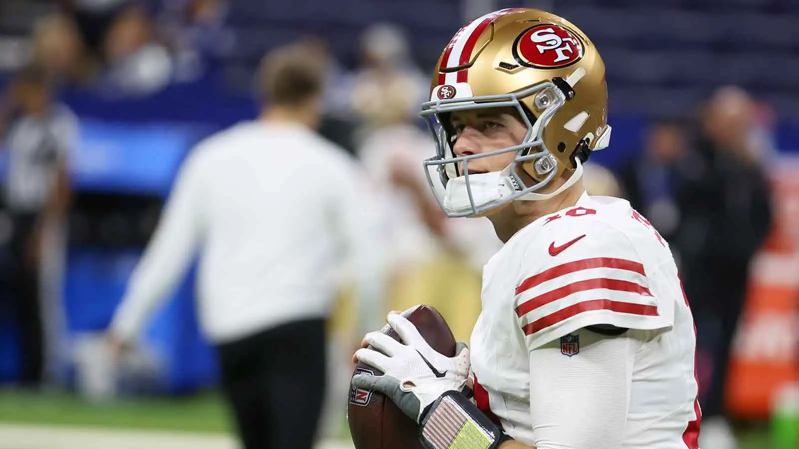 Dec 22, 2025; Indianapolis, Indiana, USA; San Francisco 49ers quarterback Mac Jones (10) warms up before the game against the Indianapolis Colts at Lucas Oil St…