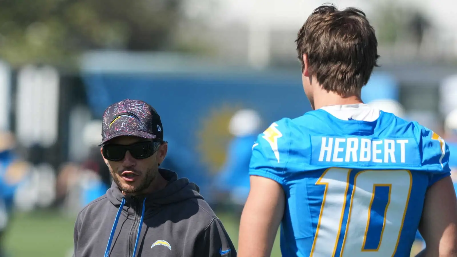 Jul 31, 2026; El Segundo, CA, USA; Los Angeles Chargers offensive coordinator Mike McDaniel (left) and quarterback Justin Herbert (10) during training camp at T…