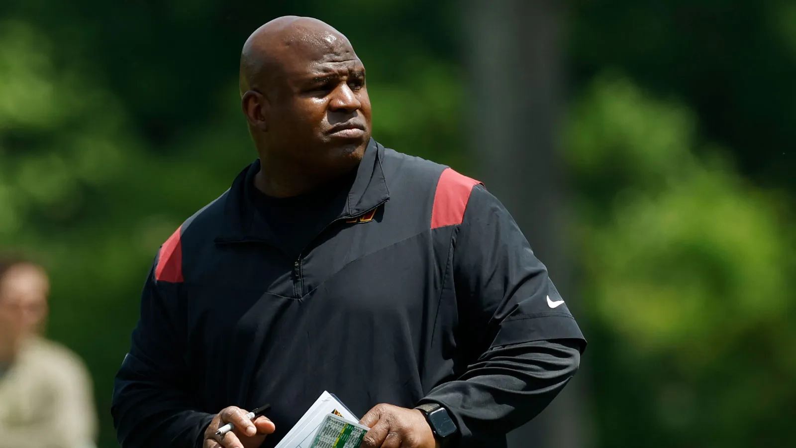 May 12, 2023; Ashburn, VA, USA; Washington Commanders assistant head coach/offensive coordinator Eric Bieniemy stands on the field during Commanders rookie mini…