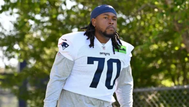 Jul 23, 2025; Foxborough, MA, USA; New England Patriots offensive tackle Caedan Wallace (70) walks to the practice field for training camp at Gillette Stadium.…