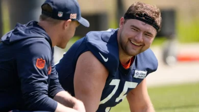 May 10, 2025; Lake Forest, IL, USA; Chicago Bears head coach Ben Johnson talks with offensive lineman (75) Ozzy Trapilo during rookie minicamp at Halas Hall. Ma…