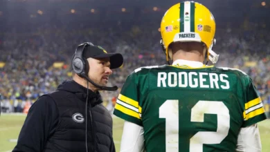 Jan 8, 2023; Green Bay, Wisconsin, USA; Green Bay Packers head coach Matt LaFleur talks with quarterback Aaron Rodgers (12) during the fourth quarter against th…