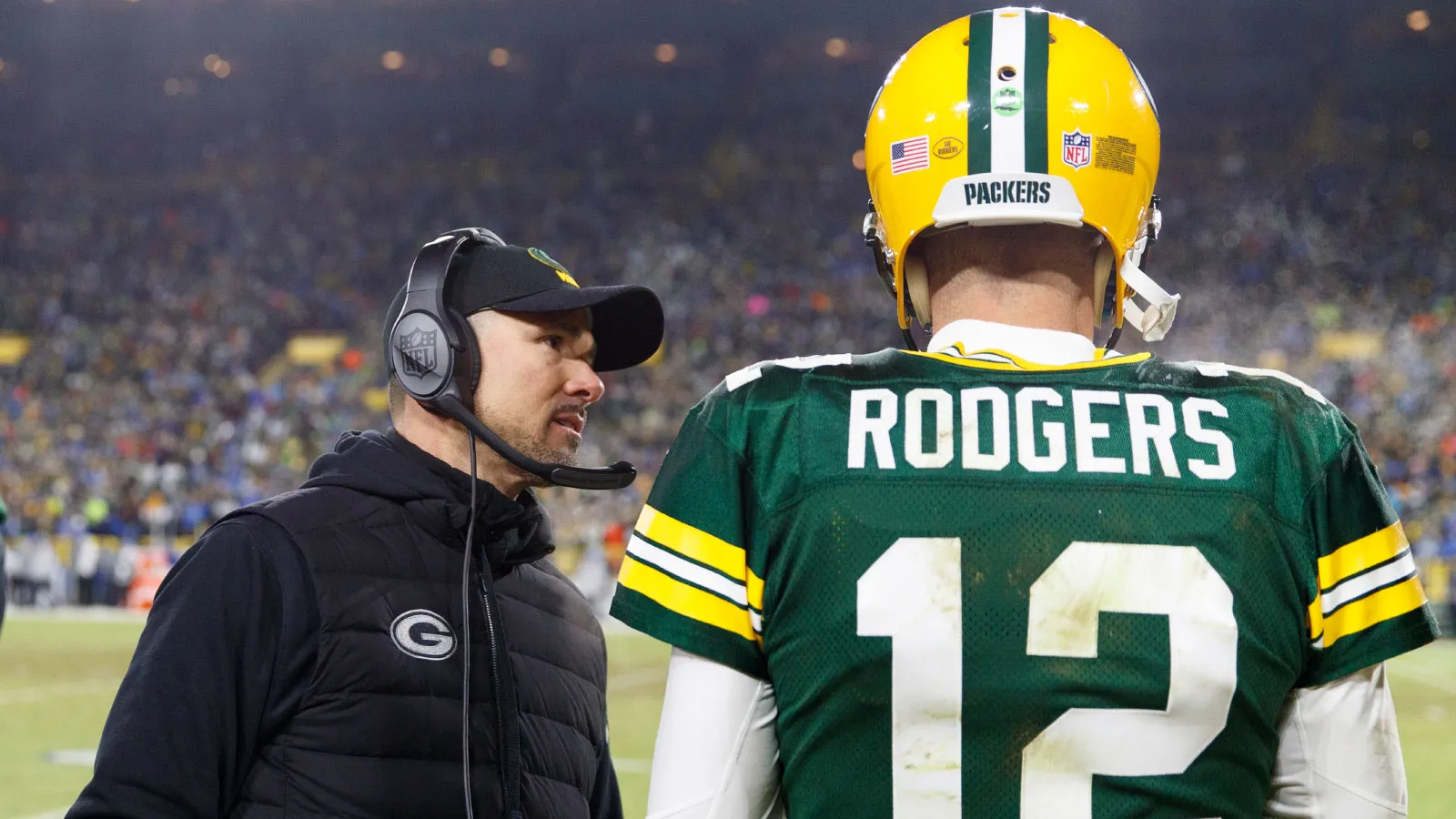 Jan 8, 2023; Green Bay, Wisconsin, USA; Green Bay Packers head coach Matt LaFleur talks with quarterback Aaron Rodgers (12) during the fourth quarter against th…