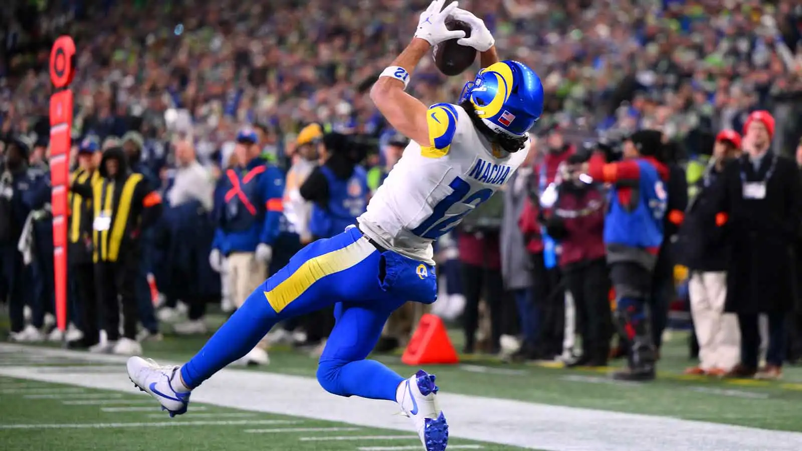 Los Angeles Rams wide receiver Puka Nacua (12) scores a touchdown against the Seattle Seahawks during the second half in the 2026 NFC Championship Game at Lumen…