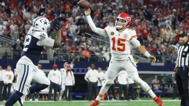 Kansas City Chiefs quarterback Patrick Mahomes (15) throws a pass for a touchdown against Dallas Cowboys defensive tackle Quinnen Williams (92) during the fourt…