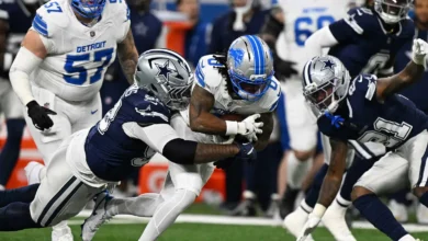 Detroit Lions running back Jahmyr Gibbs (0) is tackled by Dallas Cowboys defensive tackle Quinnen Williams (92) during the first half at Ford Field. Mandatory C…