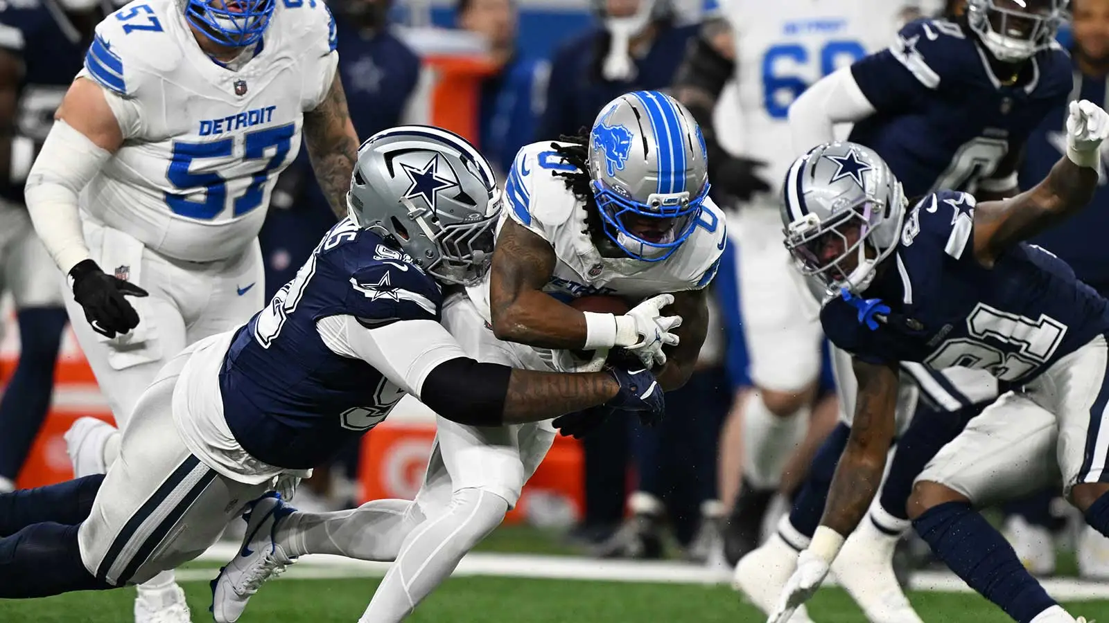 Detroit Lions running back Jahmyr Gibbs (0) is tackled by Dallas Cowboys defensive tackle Quinnen Williams (92) during the first half at Ford Field. Mandatory C…