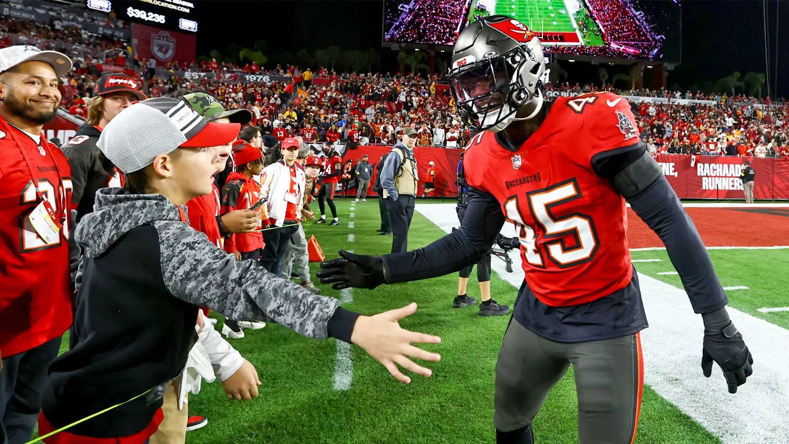 Jan 12, 2025; Tampa, Florida, USA; Tampa Bay Buccaneers linebacker Deion Jones (45) greets a fan before a NFC wild card playoff against the Washington Commander…