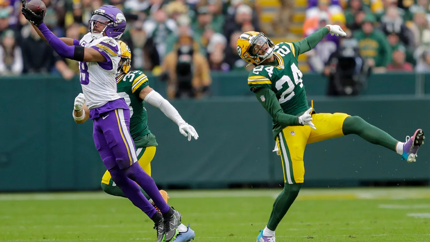 Nov 23, 2025; Green Bay, Wisconsin, USA; Minnesota Vikings wide receiver Justin Jefferson (18) makes a first down reception against Green Bay Packers cornerback…