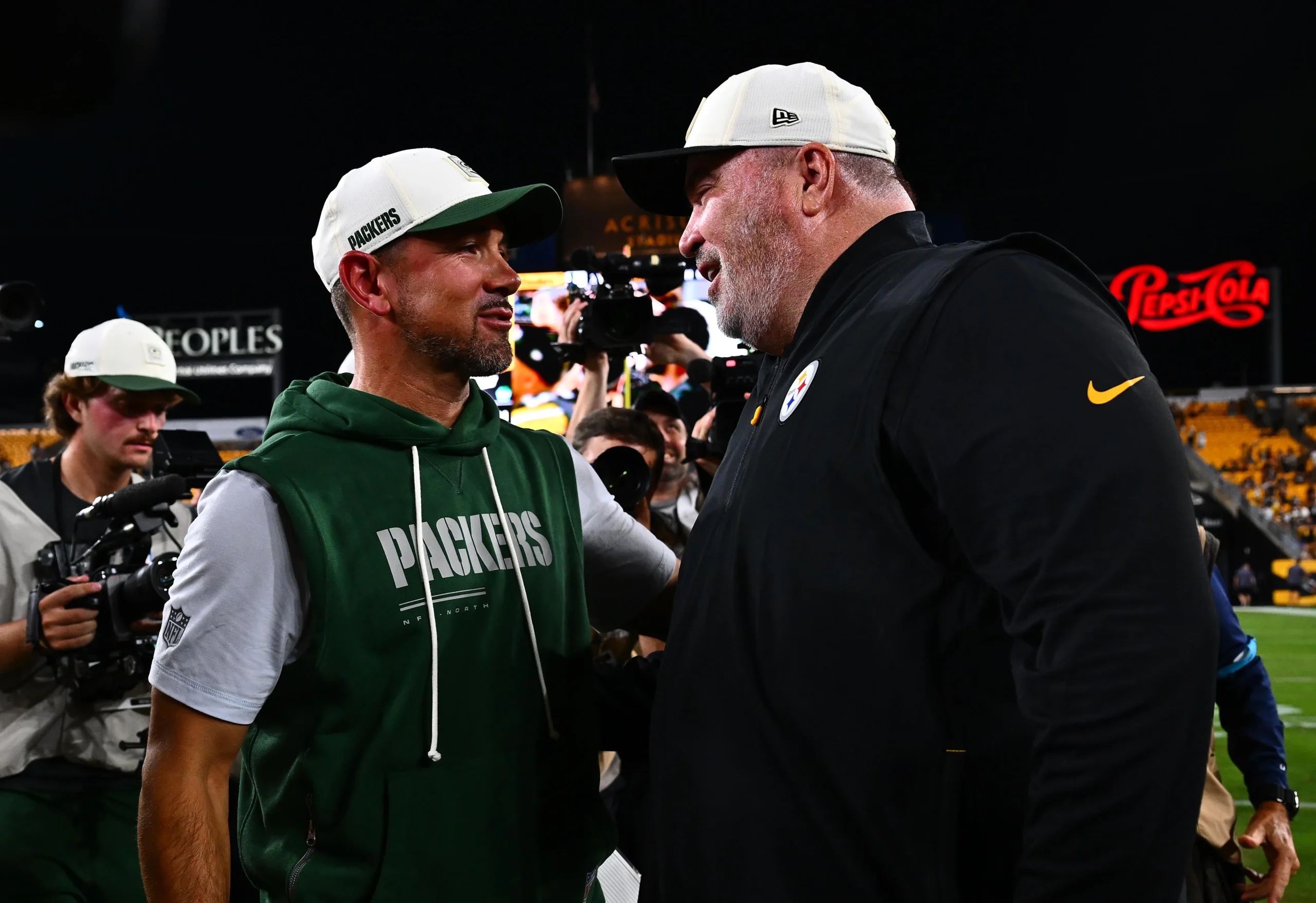 PITTSBURGH, PENNSYLVANIA - AUGUST 13: Head coach Matt LaFleur of the Green Bay Packers (L) talks with head coach Mike McCarthy of the Pittsburgh Steelers after…
