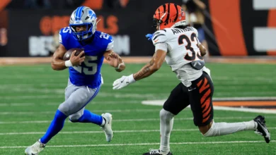 CINCINNATI, OHIO - AUGUST 13: Jacob Saylors #25 of the Detroit Lions is chased by Daijahn Anthony #33 of the Cincinnati Bengals during the second quarter of a p…