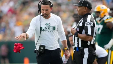 Sep 15, 2024; Green Bay, Wisconsin, USA; Green Bay Packers head coach Matt LaFleur throws the challenge flag in front of Down Judge Patrick Holt (106) during th…