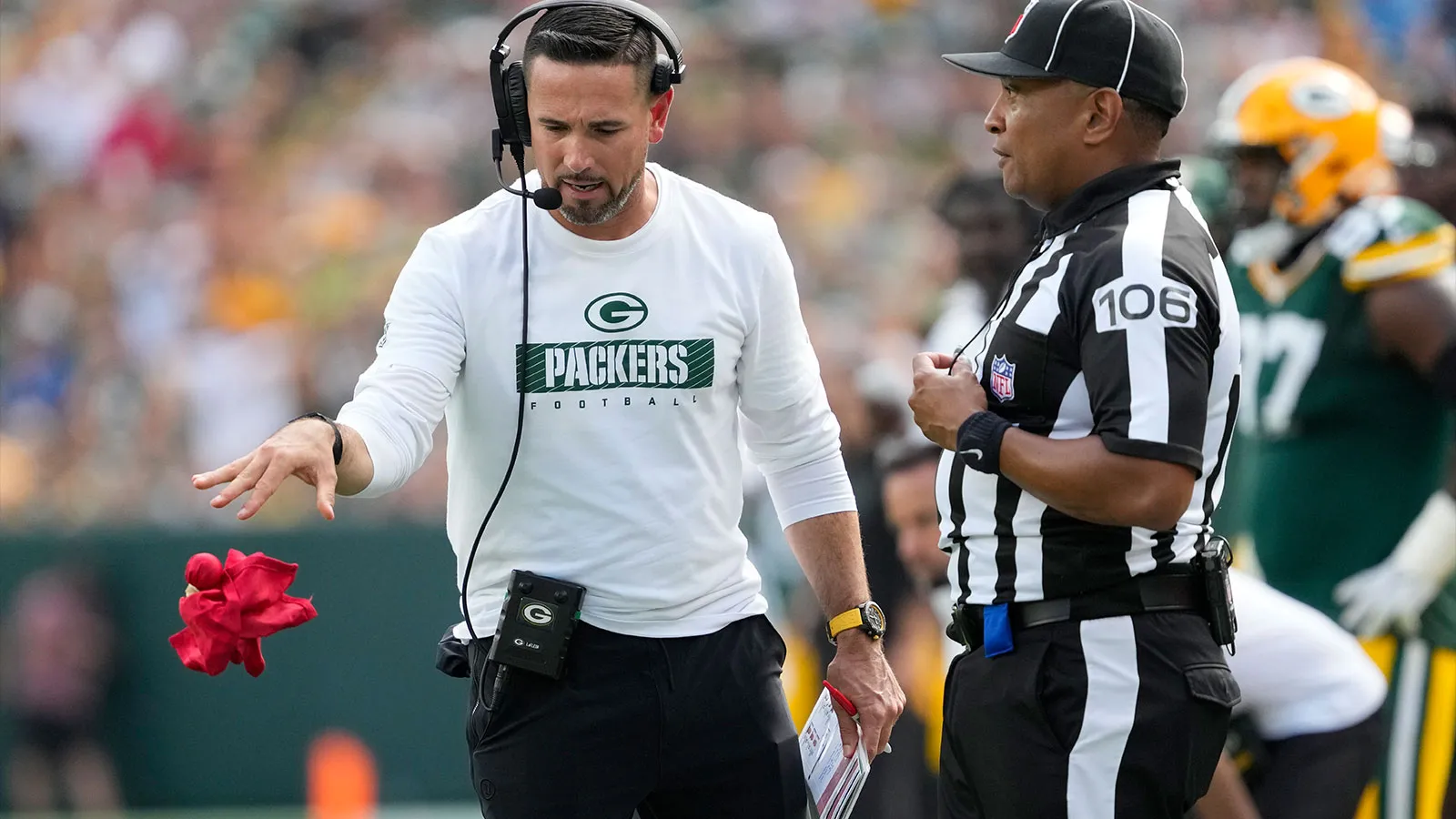 Sep 15, 2024; Green Bay, Wisconsin, USA; Green Bay Packers head coach Matt LaFleur throws the challenge flag in front of Down Judge Patrick Holt (106) during th…